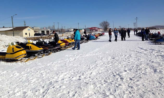 A row of vintage sleds are lined up at Elk Point's annual Vintage Snowmobile Rally.