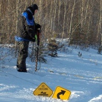 Watt Mountain Wanderers snowmobile club President, Barry Toker working on signage.