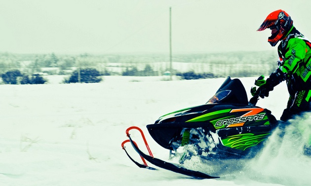 A snowmobiler out on a ride.