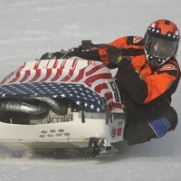 Glen Hart leaning hard in a race.