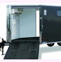 A photo of a sled trailer with the back ramp down. 