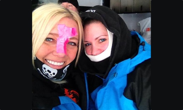 Stephanie Schwartz and Darcie Downy with duct tape on their faces to fend off the cold.