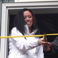 Terry Watt's daughter, Llana Malmberg, along with  JayDee McClure cutting the ribbon of the newly finished Terry Watt memorial cabin.  