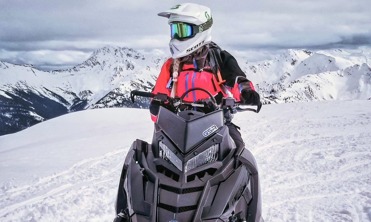 Angel Sterling rides a 2020 Polaris Khaos on the top of a snowy mountain. 