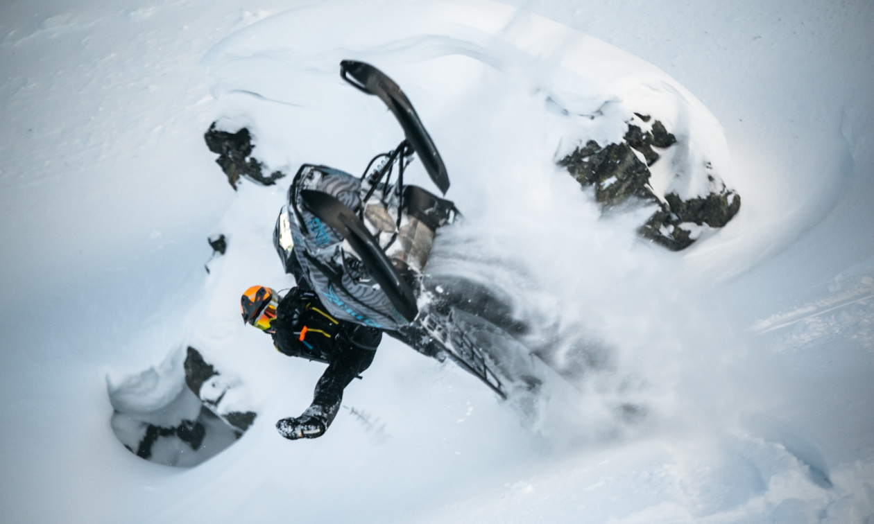 Mason Kenyon gets air on his blue and black snowmobile. 