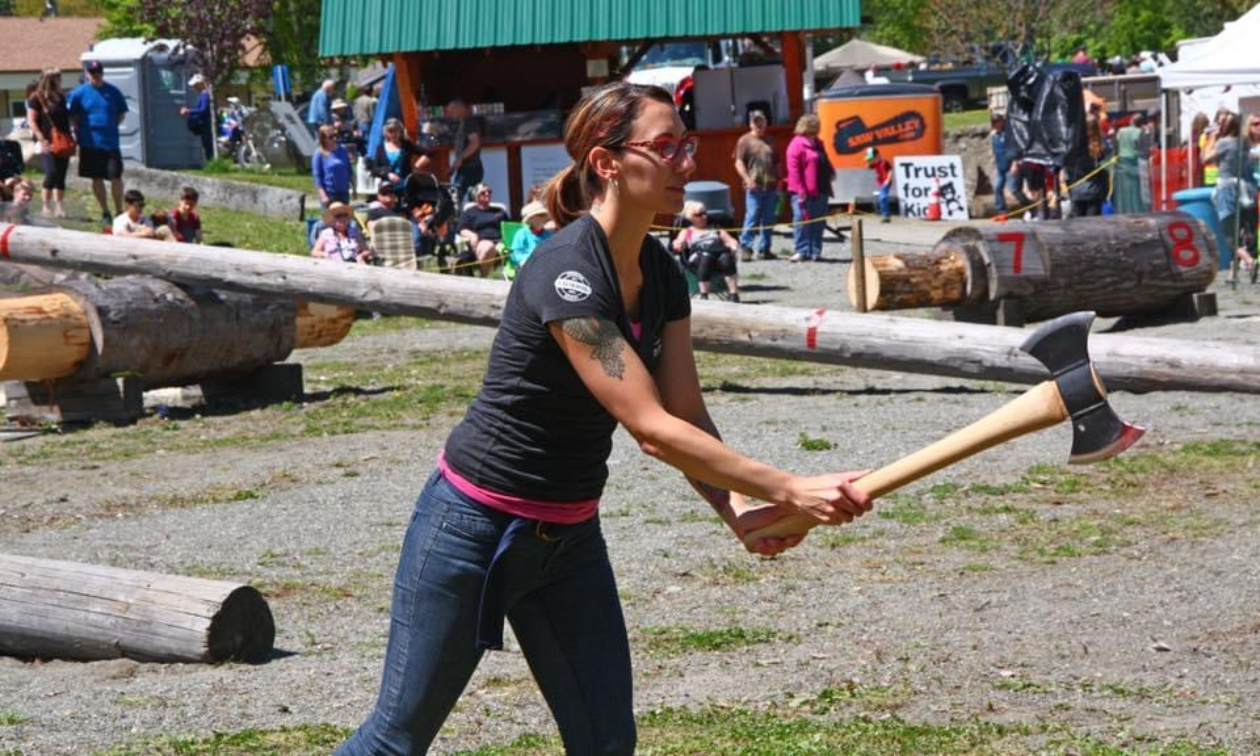 Alysha Vlahovich holds a large double-sided axe during an axe throwing competition. 