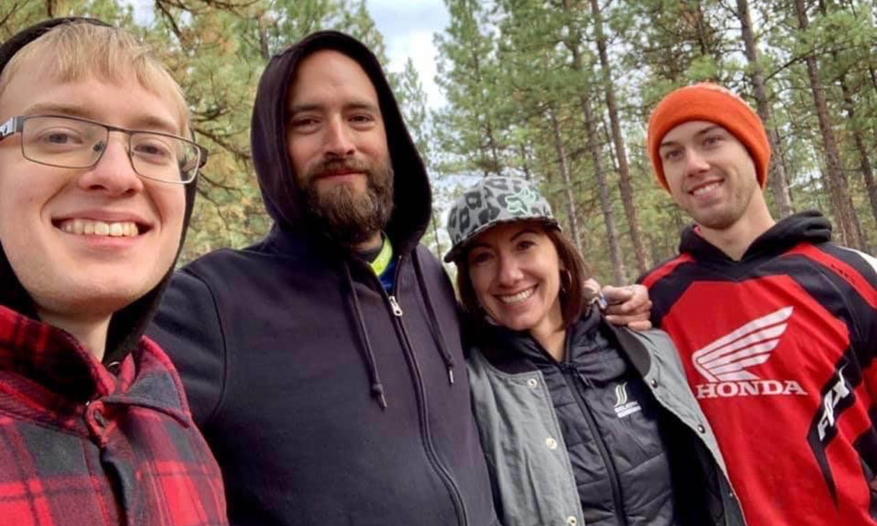 Alysha Vlahovich smiles next to her adult sons and boyfriend. 