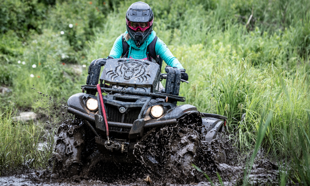 Cassandra Mainville drives through mud on her black 2018 Yamaha Kodiak 700 EPS SE ATV. 