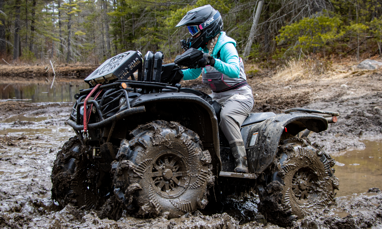 Cassandra Mainville rides a black ATV in the mud in Petawawa, Ontario.