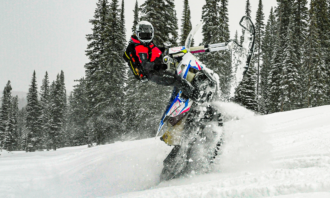 Cassandra Prochera does a massive wheelie on the back track of her snow bike. 