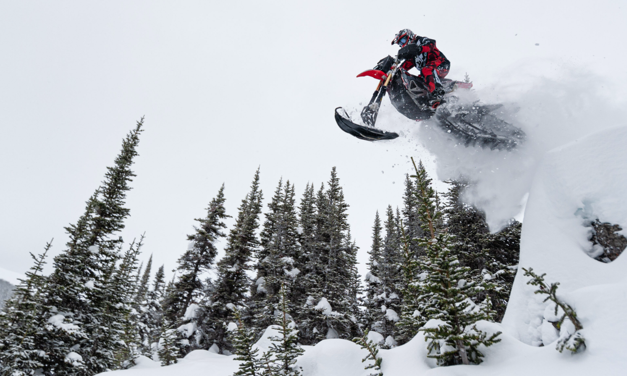 Curtis Hofsink gets massive air off a snowy jump on his red 2018 Honda CRF450RX. 