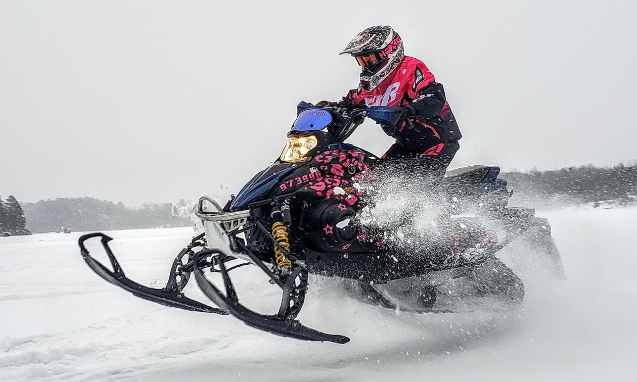 Jessica Rainville rides a black and pink 2007 Yamaha Phazer FX snowmobile. 