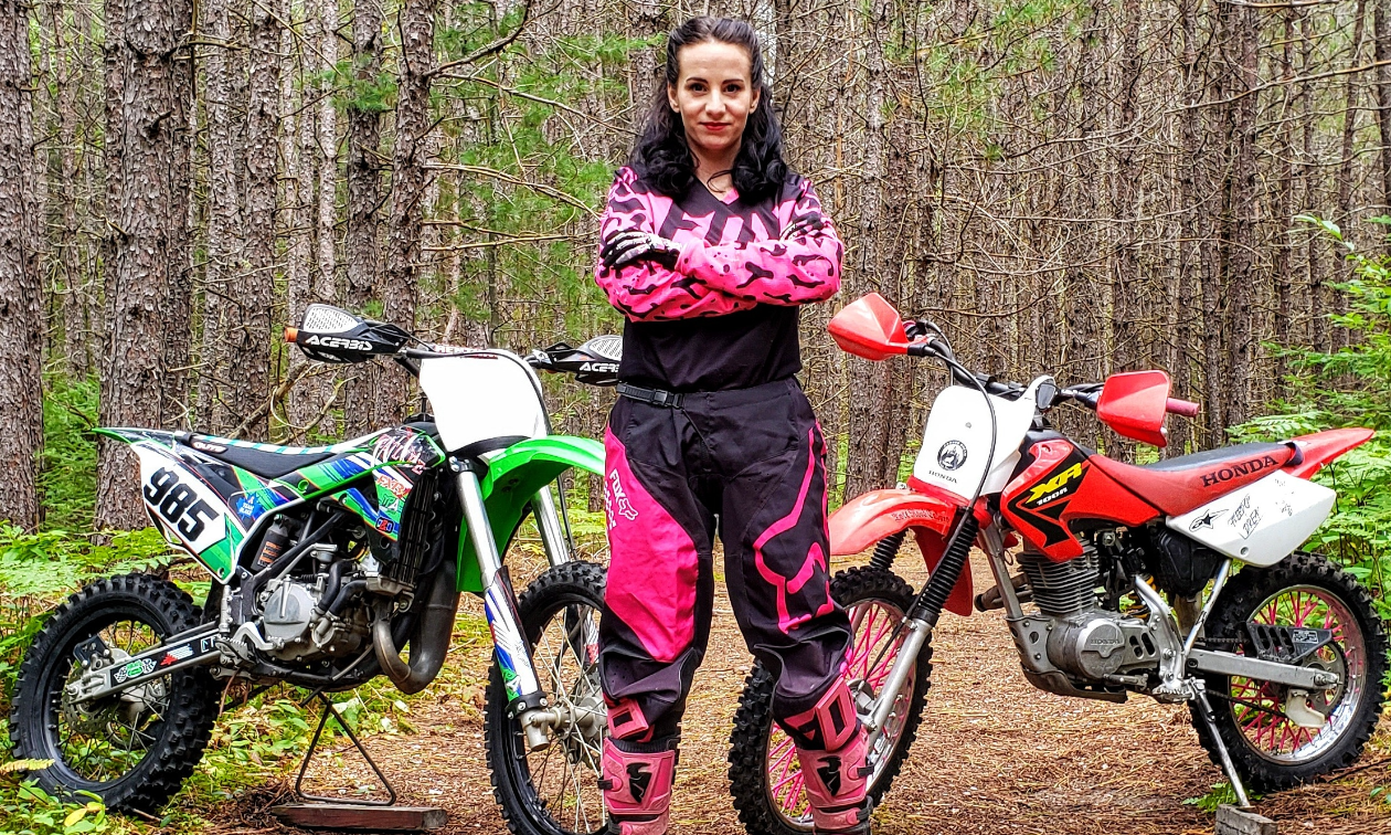 Jessica Rainville poses with her 2018 Kawasaki KX100 and 2003 Honda XR100 dirt bikes. 