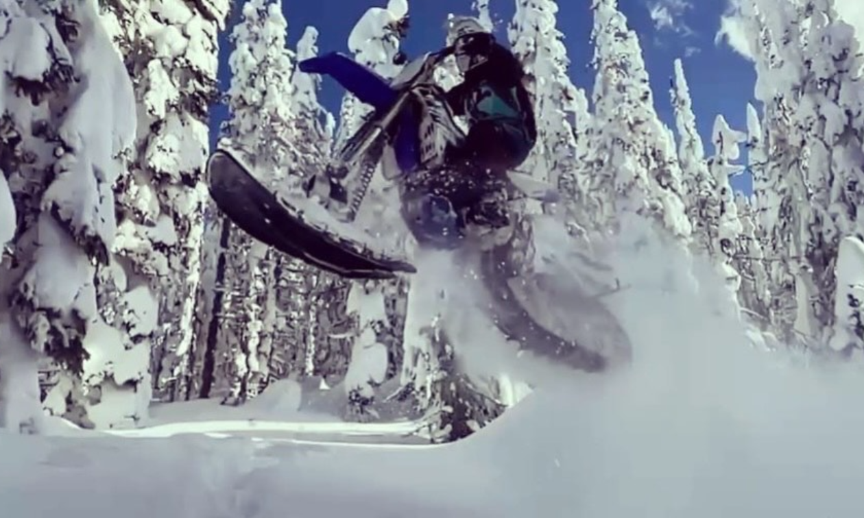 Sammi Lynn Clayton goes over a jump through snowy terrain on her Yamaha YZ450F with a Yeti 120 SS. 