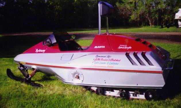 1985 Manta sled, red and white in colour. 