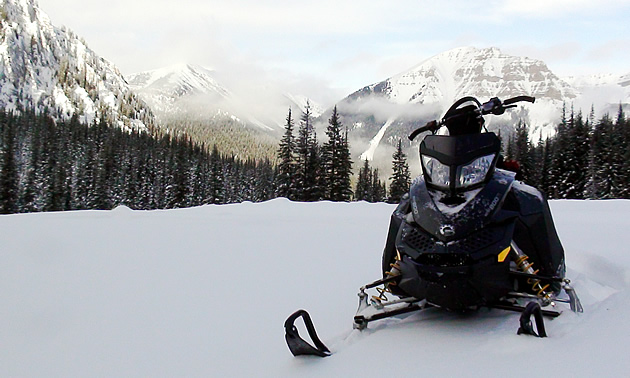 A snowmobile sits ready to ride in picturesque Elkford, BC.