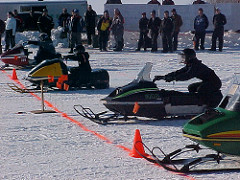 Sleds line up at the start of a vintage drag race. 