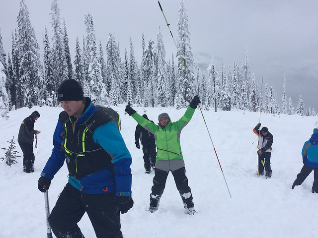 A group of people on the mountain practicing their avalanche skills training.