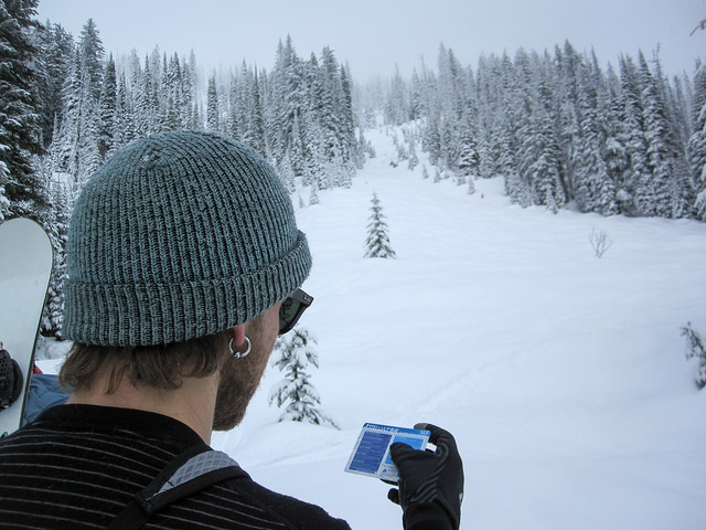 AST 1 student Clayton Zacharias using the Avaluator developed by Avalanche Canada to identify avalanche risks before crossing underneath a path.