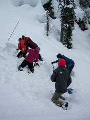 AST 1 students led by David Lussier practicing rescuing a victim with multiple shovelers.