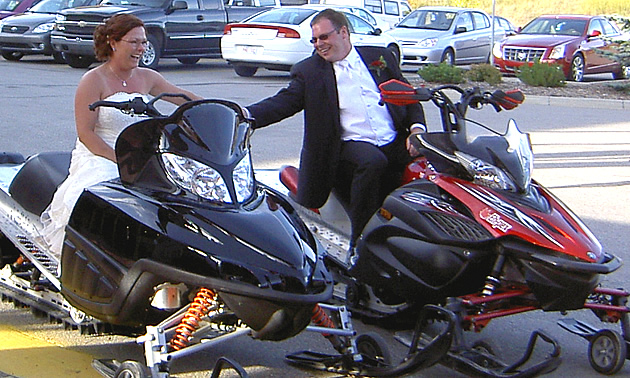 A couple getting married on sleds. 