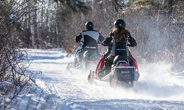 New snowmobile riders on the trail. 