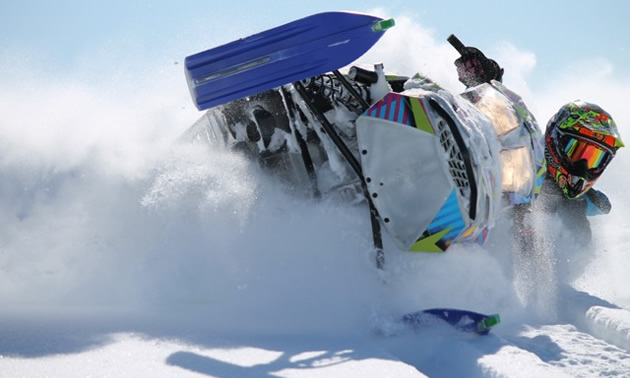 Jamie Iwaschuk laying his sled over in a pow carve. 