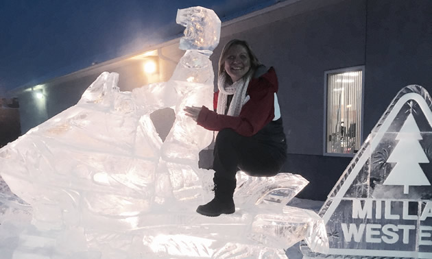 Maryann Chichak on a snowmobile ice sculpture during the sled invasion. 