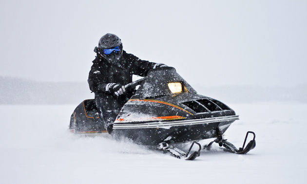 A rider on a vintage Arctic Cat Pantera snowmobile. 
