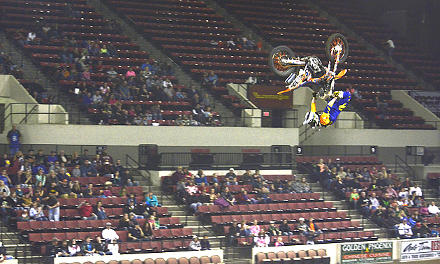 Backflip on a dirt bike during Big Air Bash. 