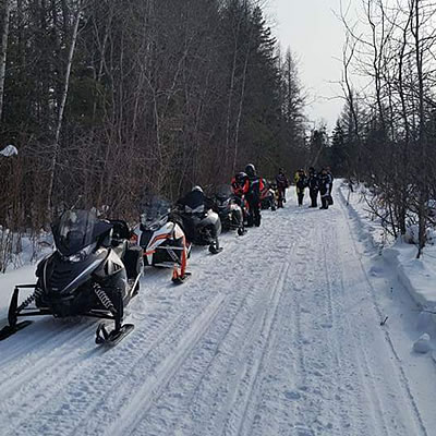 Snowmobilers lined up on a trail near Powerview-Pine Falls. 