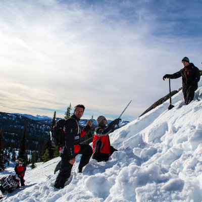 Snowmobilers check terrain for risky conditions