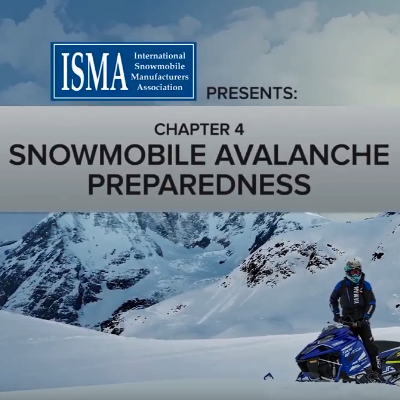 Snowmobilers converse before heading out for a trip.