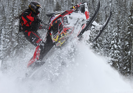 Girl riding snowmobile.