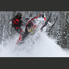 Girl riding snowmobile.