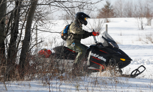 A prairie sledder goes over a trail. 