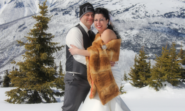 Tyler and Vicki Barrett rode snowmobiles to the top of Lucille Mountain on their wedding day for a once-in-a-lifetime photo shoot.