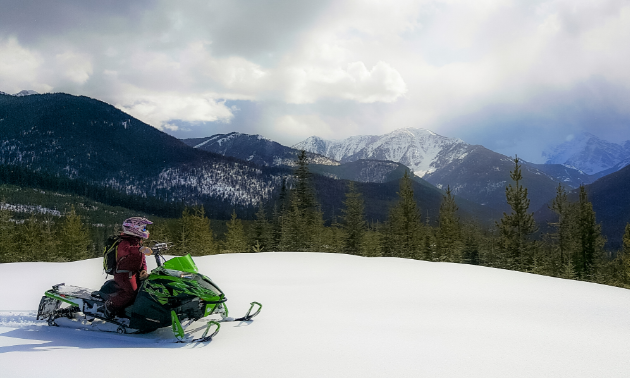A snowmobiler looks out across the mountains in Fernie, B.C.