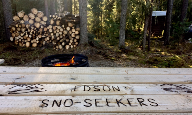 A picnic table with Edson Sno Seekers printed into the wood.