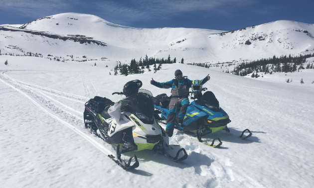 Allan Bouchard smiles on his snowmobile in the backcountry.