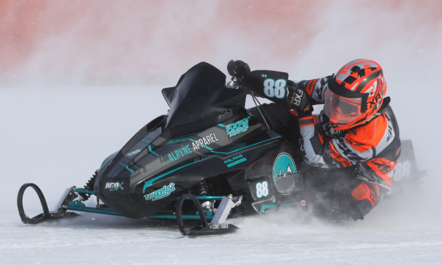 Brennan Boxall leans into a turn during an ice oval race.