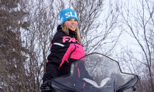 Charlene Isfeld poses on her snowmobile. 