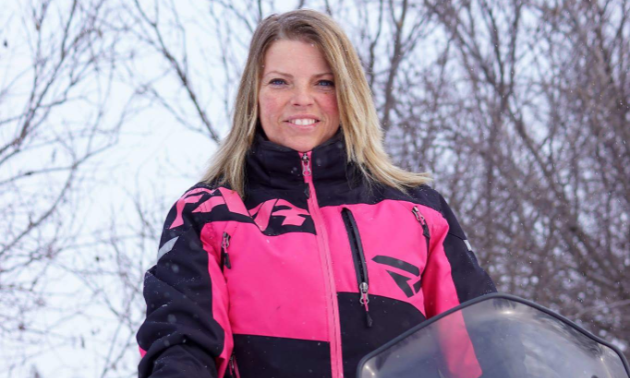 Charlene Isfeld stands out against a white backdrop by wearing pink.