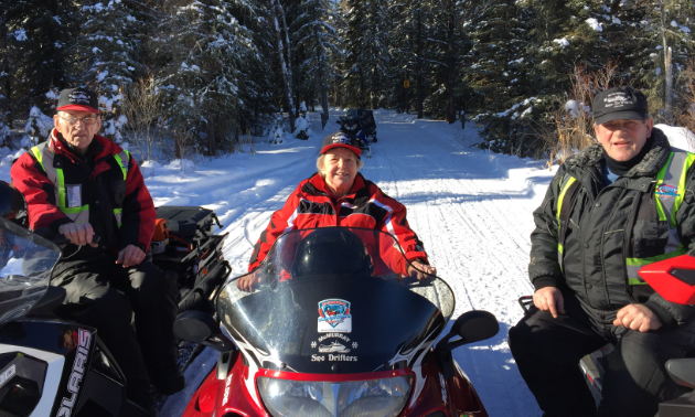 (L to R) Elburne, Freda and Barry Bean sit on their sleds in Fort McMurray. 