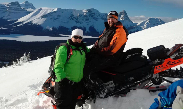 Les and Amanda L’Heureux pose on their snowmobiles in Kakwa Provincial Park.