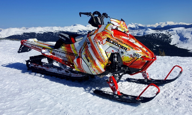 A red and white Polaris Axys 800 RMK. 