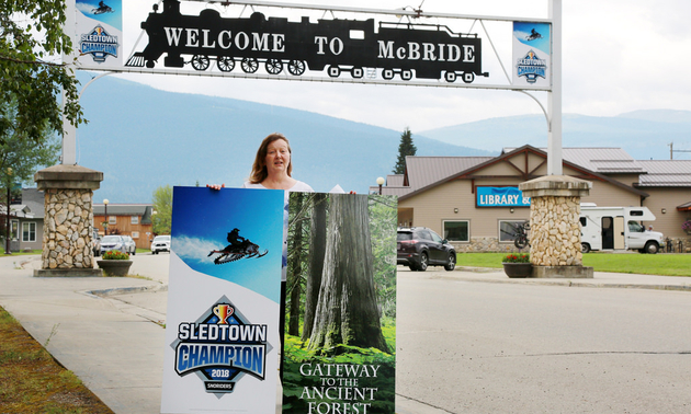 Loranne Martin, mayor of McBride, B.C., displays new signage downtown to promote the city’s 2018 SledTown ShowDown victory.