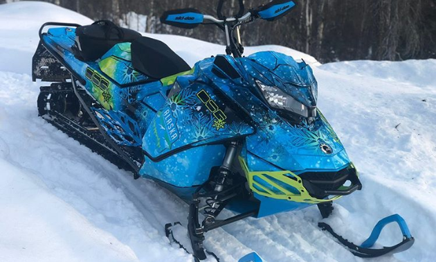Kim Black’s aquatic blue snowmobile looks slick.