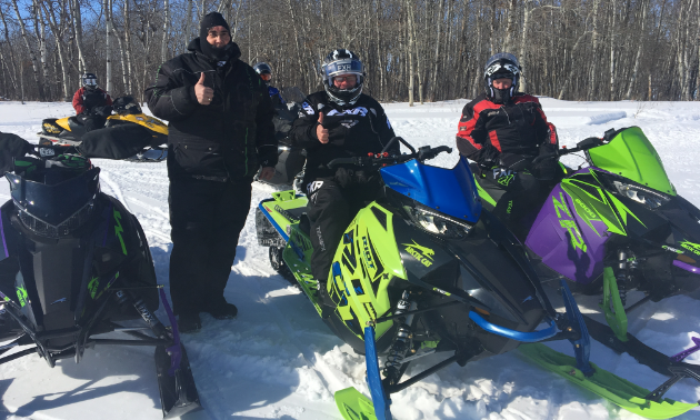 (On left) Stan Langley stands next to an Arctic Cat Riot, Arctic Cat 8000 and Arctic Cat Alpha.