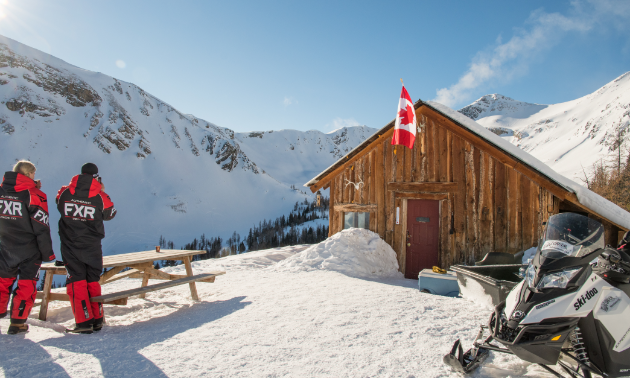 Snowmobilers take a break next to a warm-up shelter.